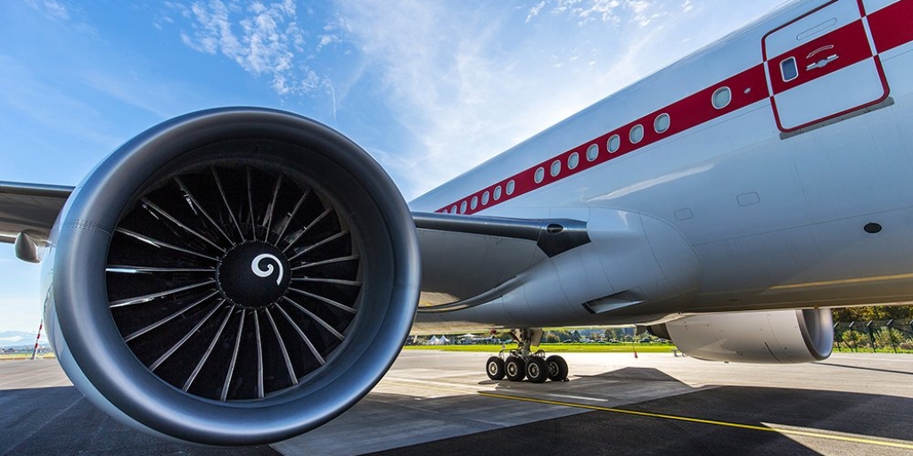 a large jet plane with the left jet engine in the foreground